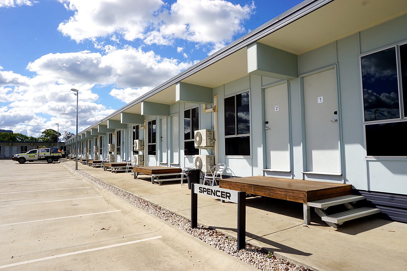Row of ground-floor rooms with parking at the door