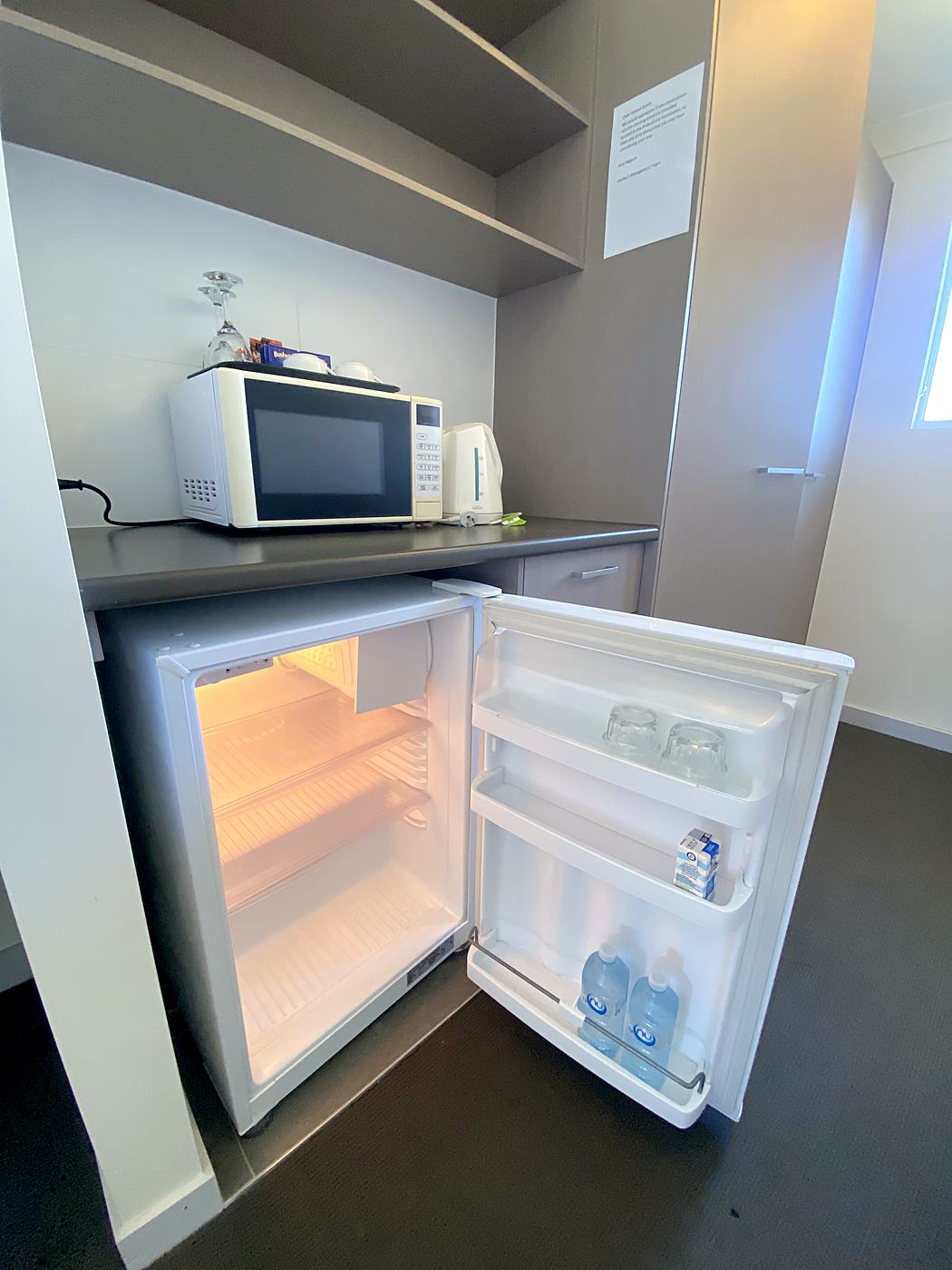 Kitchenette with fridge, microwave and kettle