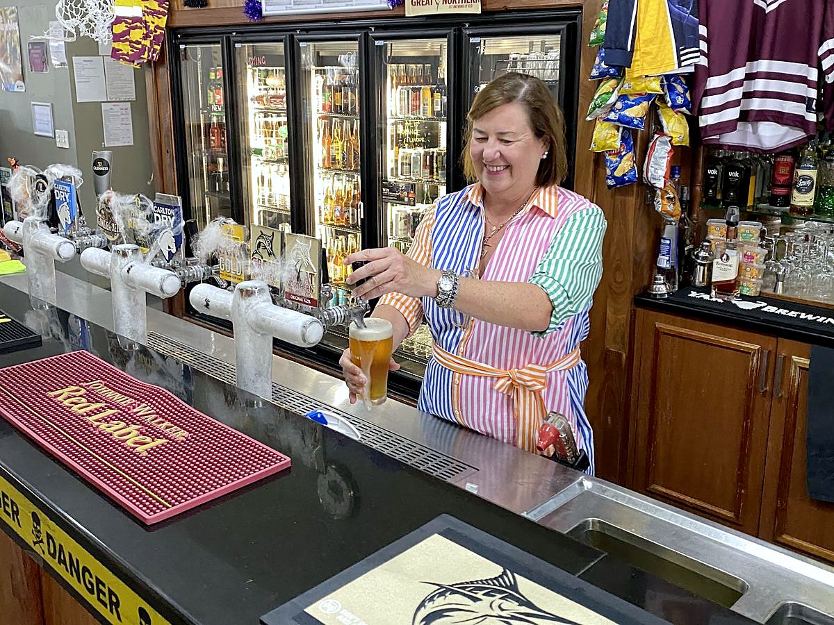 Staff member pouring a beer at the Tavern bar