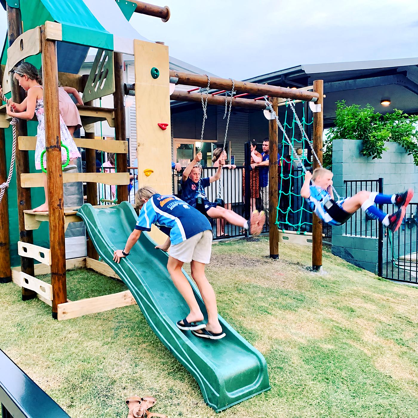 Children on the slide and swings in the beer garden playground