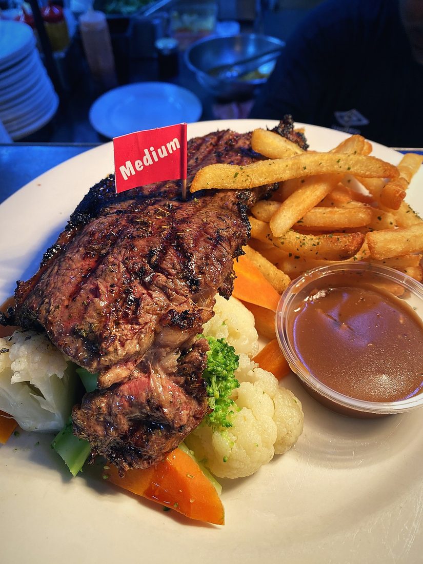 Char-grilled steak with chips, vegetables and gravy from the Dooleys bistro