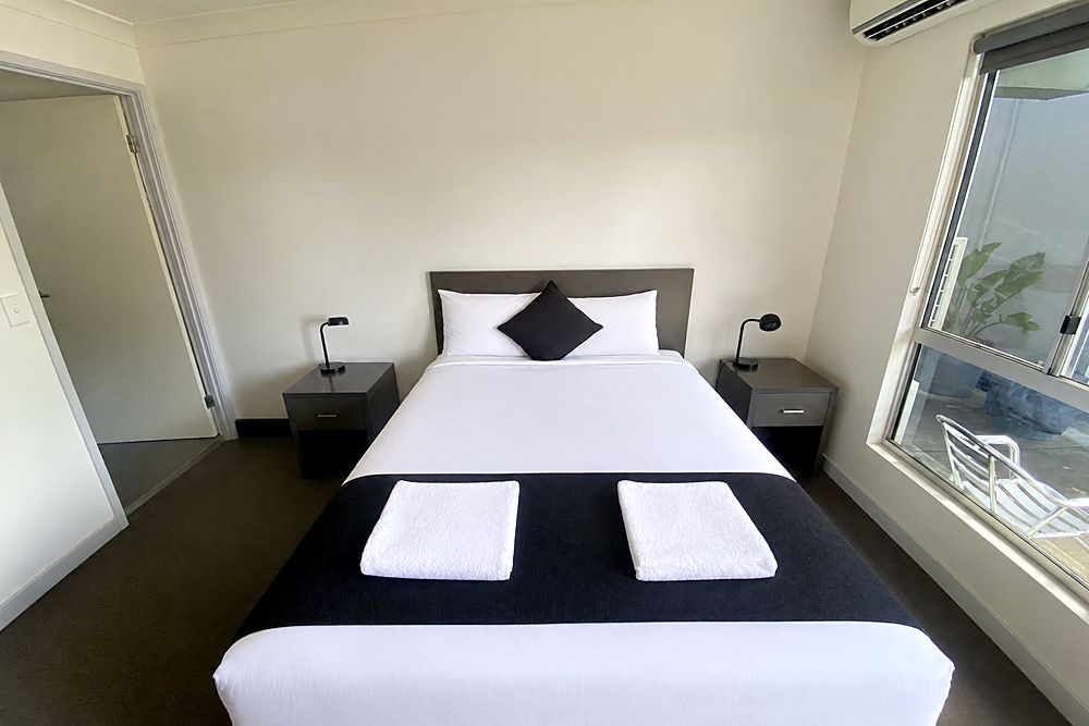 Deluxe Queen room with a queen bed, bedside tables and ensuite